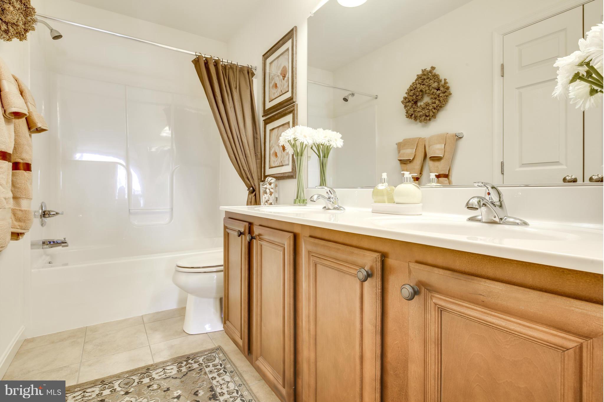 5920 Cypress Springs Road Elkridge, MD 21075 - Photo 24 of 28 a bathroom with a sink a toilet and a mirror