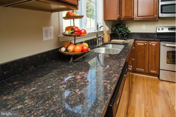 5920 Cypress Springs Road Elkridge, MD 21075 - Photo 4 of 28 a kitchen with stainless steel appliances granite countertop a stove a sink and a microwave