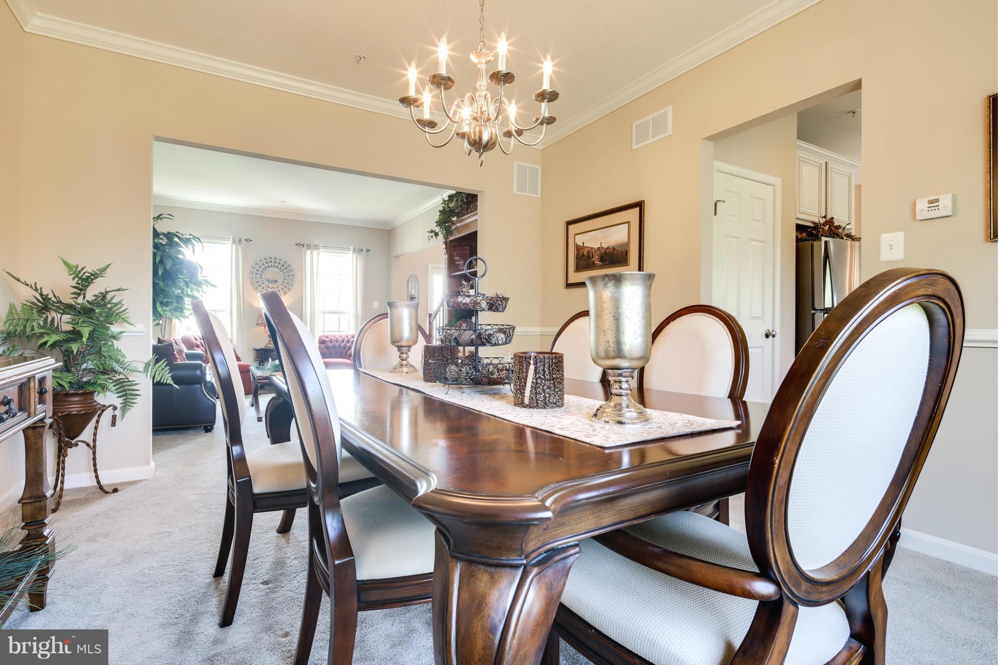 5920 Cypress Springs Road Elkridge, MD 21075 - Photo 10 of 28 a dining room with furniture and chandelier
