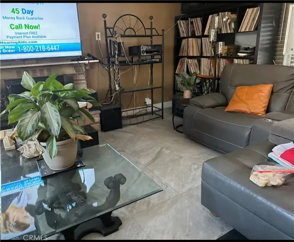 a living room with furniture and flowers