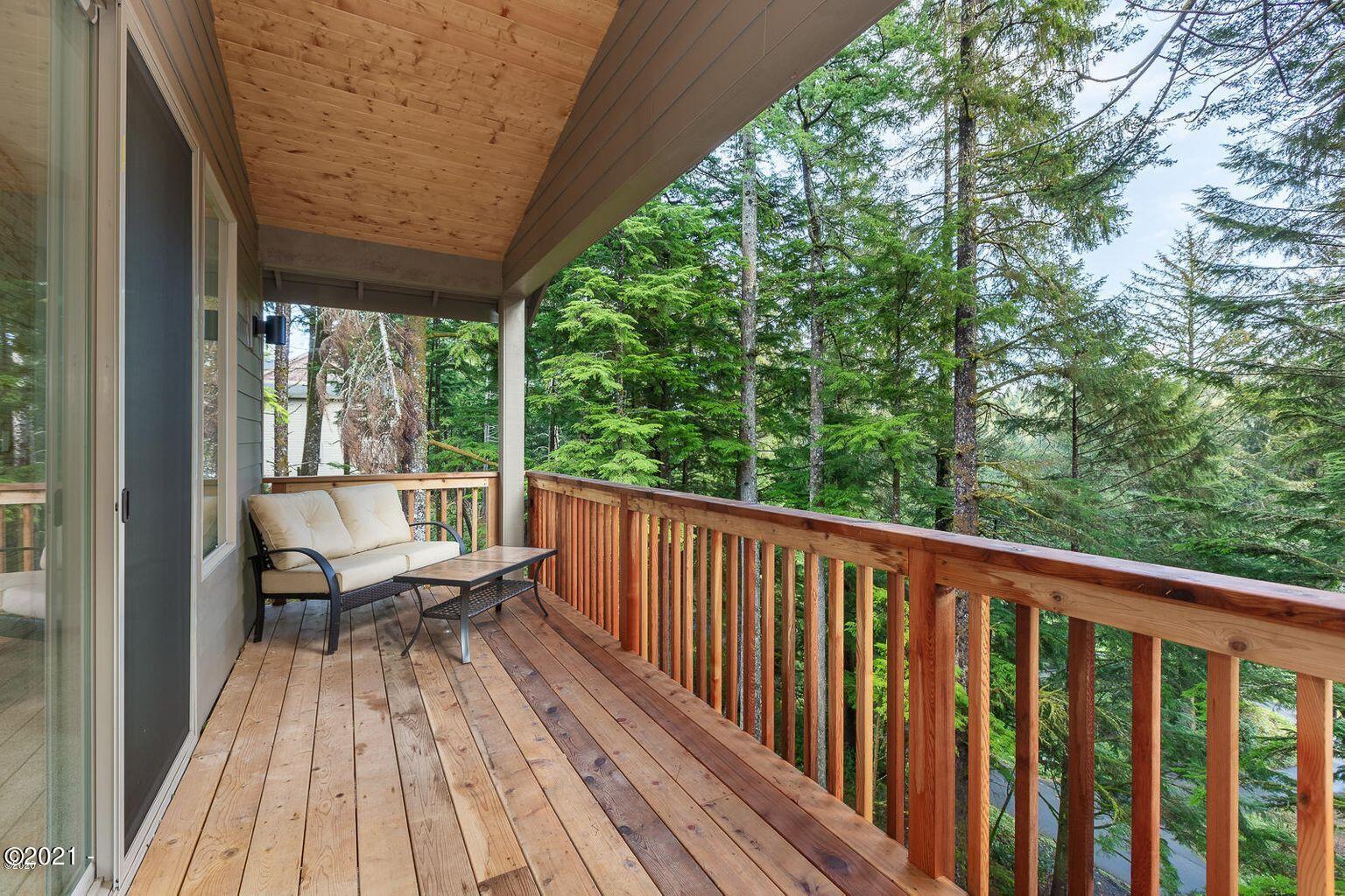 15 Big Tree Road Gleneden Beach, OR 97388 - Photo 13 of 28 a view of balcony with wooden floor and outdoor seating