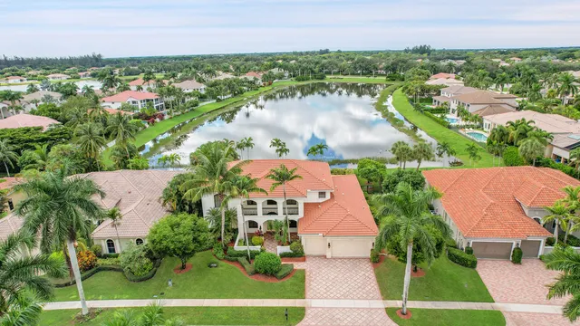 a view of a house with a yard and potted plants