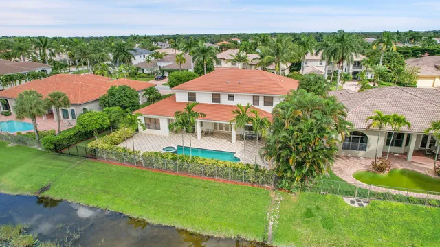 an aerial view of residential houses with outdoor space and trees
