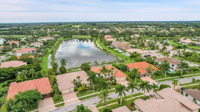 an aerial view of residential houses with outdoor space and trees all around