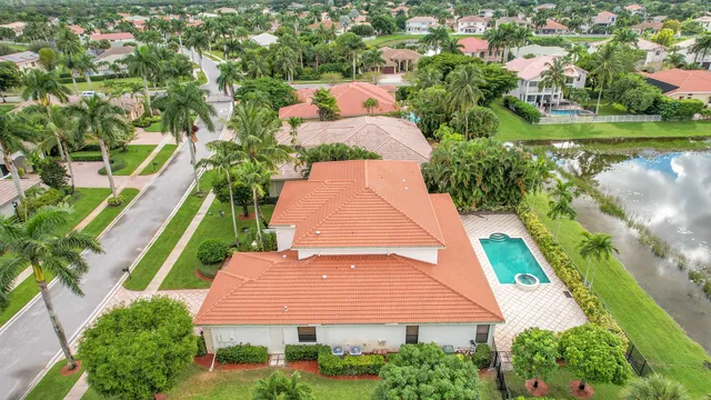 an aerial view of a house with a garden and swimming pool