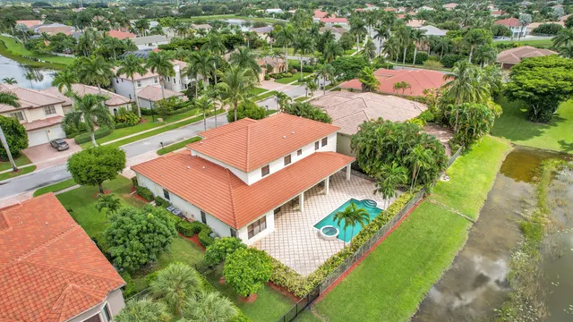 an aerial view of a house with a yard and lake view