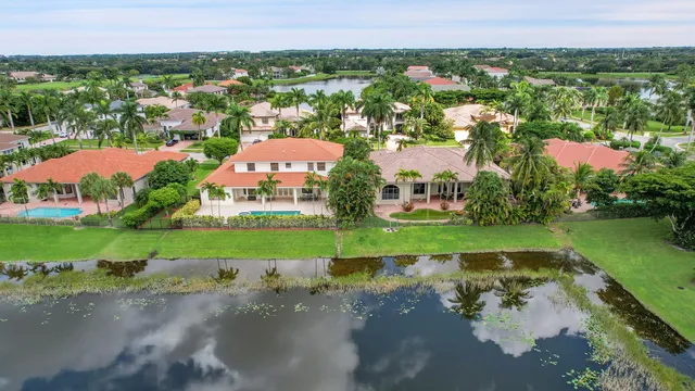 a front view of a house with a yard and potted plants