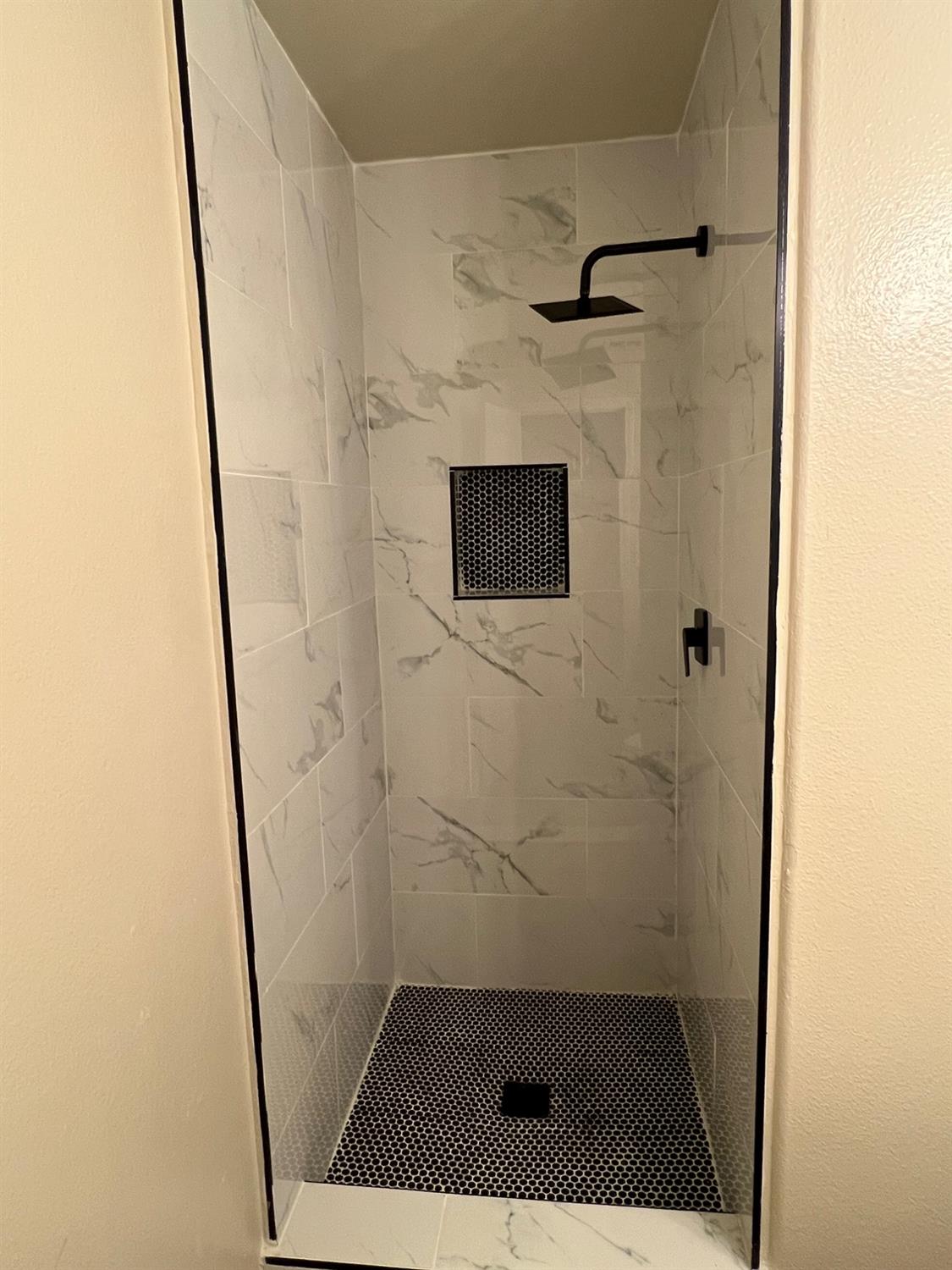 5930 West Birch Avenue Fresno, CA 93722 - Photo 12 of 32 a bathroom with a shower