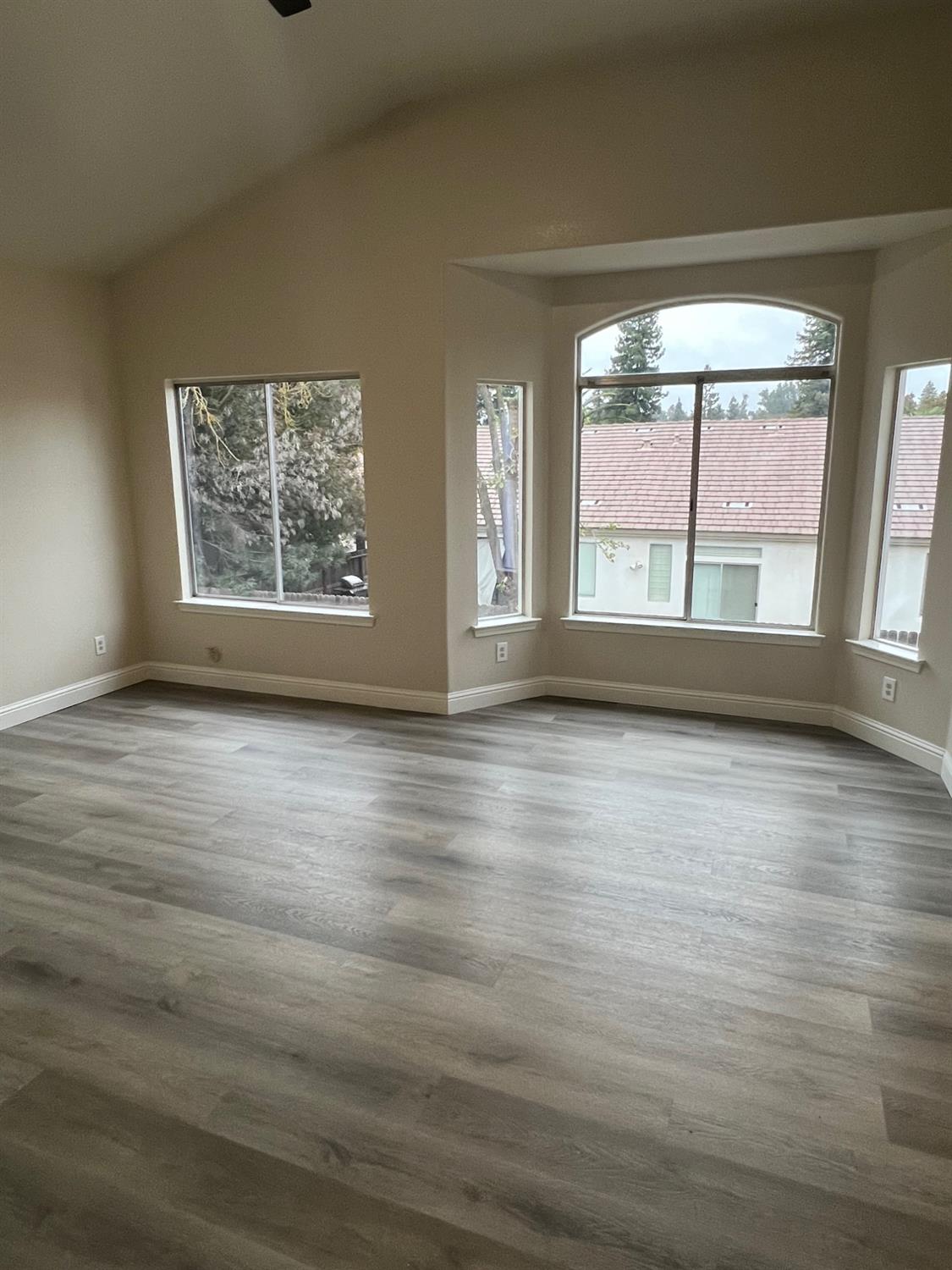 5930 West Birch Avenue Fresno, CA 93722 - Photo 16 of 32 an empty room with wooden floor and windows