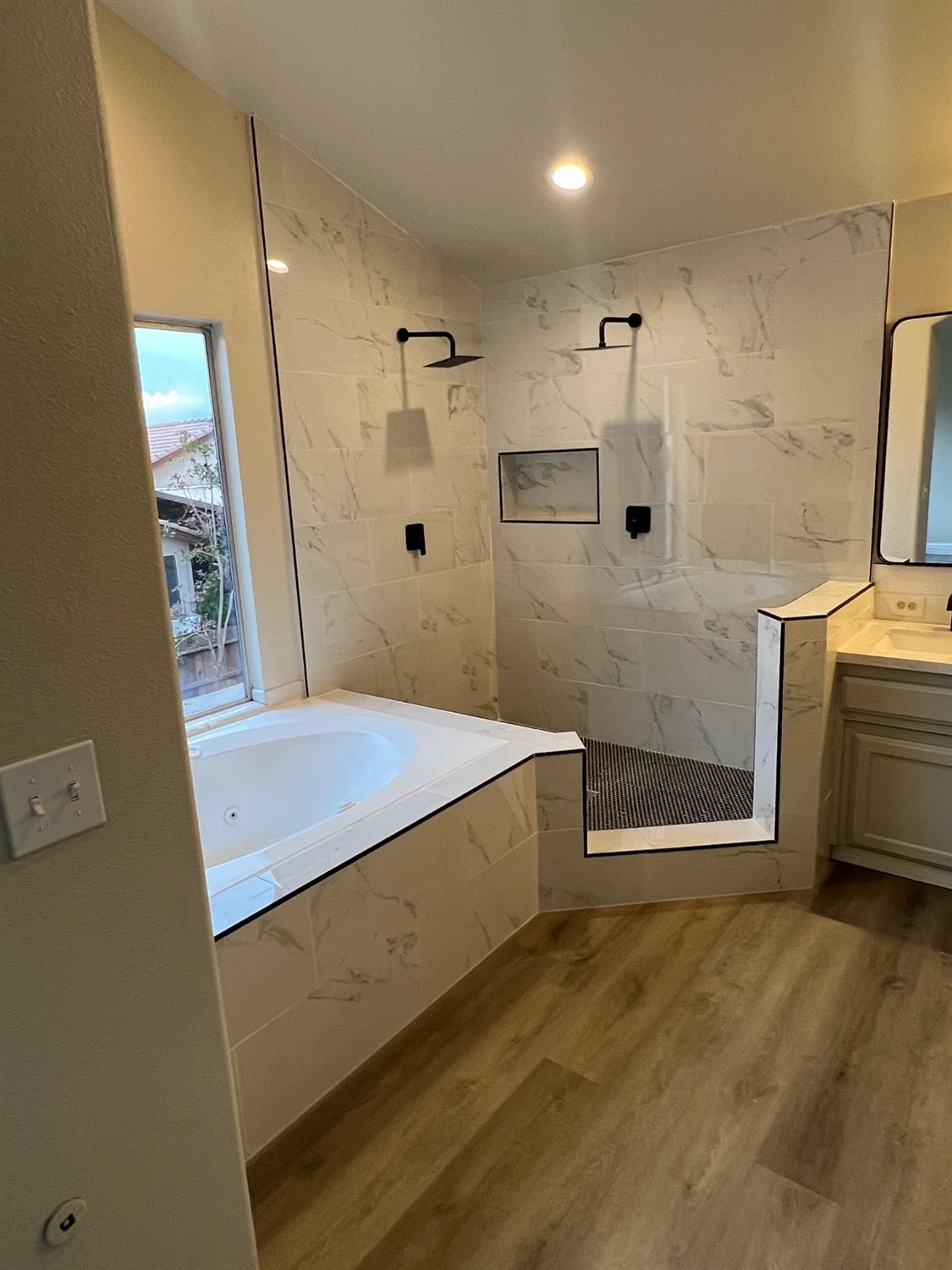 5930 West Birch Avenue Fresno, CA 93722 - Photo 18 of 32 a bathroom with a tub and a shower