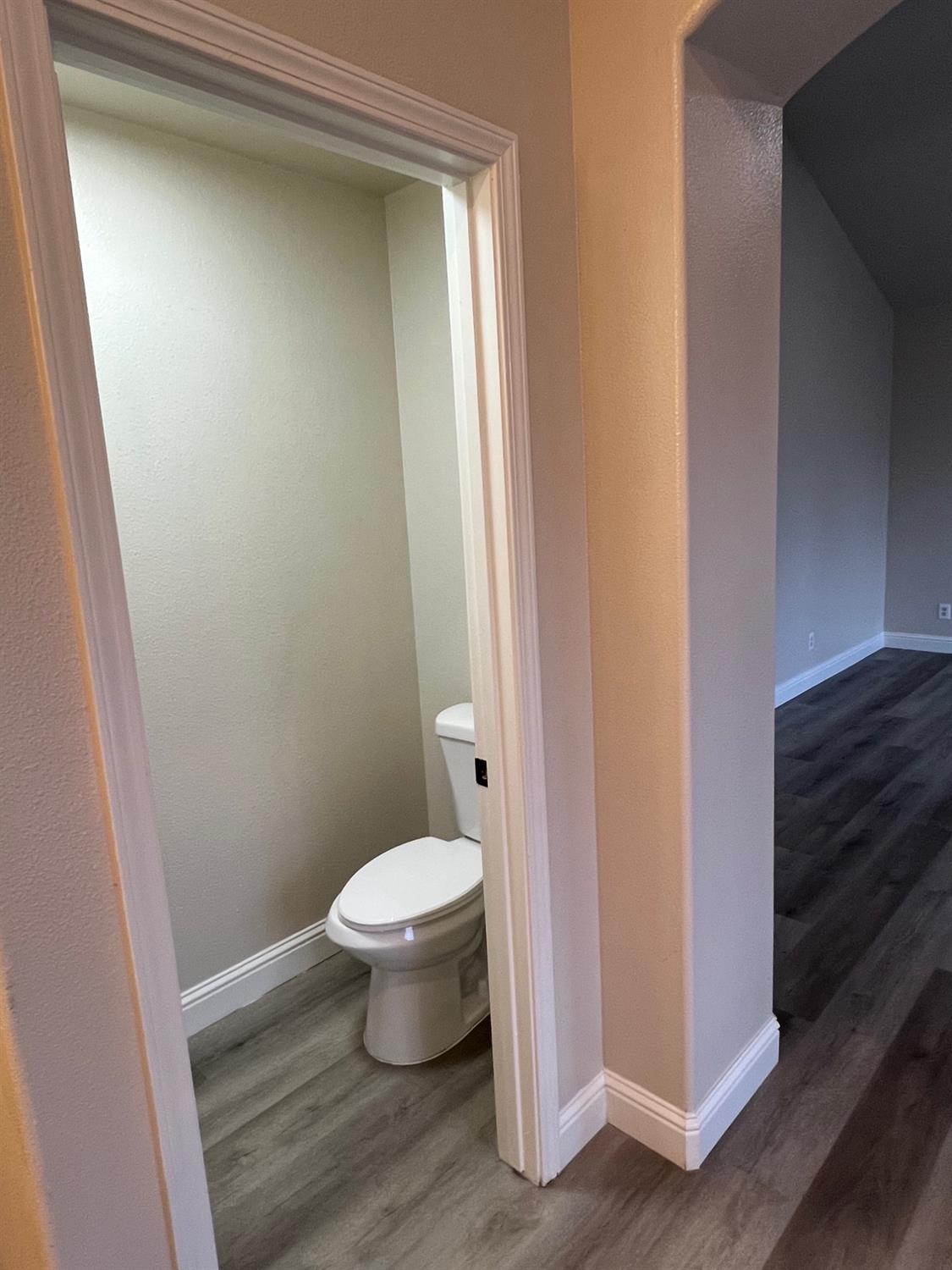 5930 West Birch Avenue Fresno, CA 93722 - Photo 20 of 32 a bathroom with a toilet and a shower