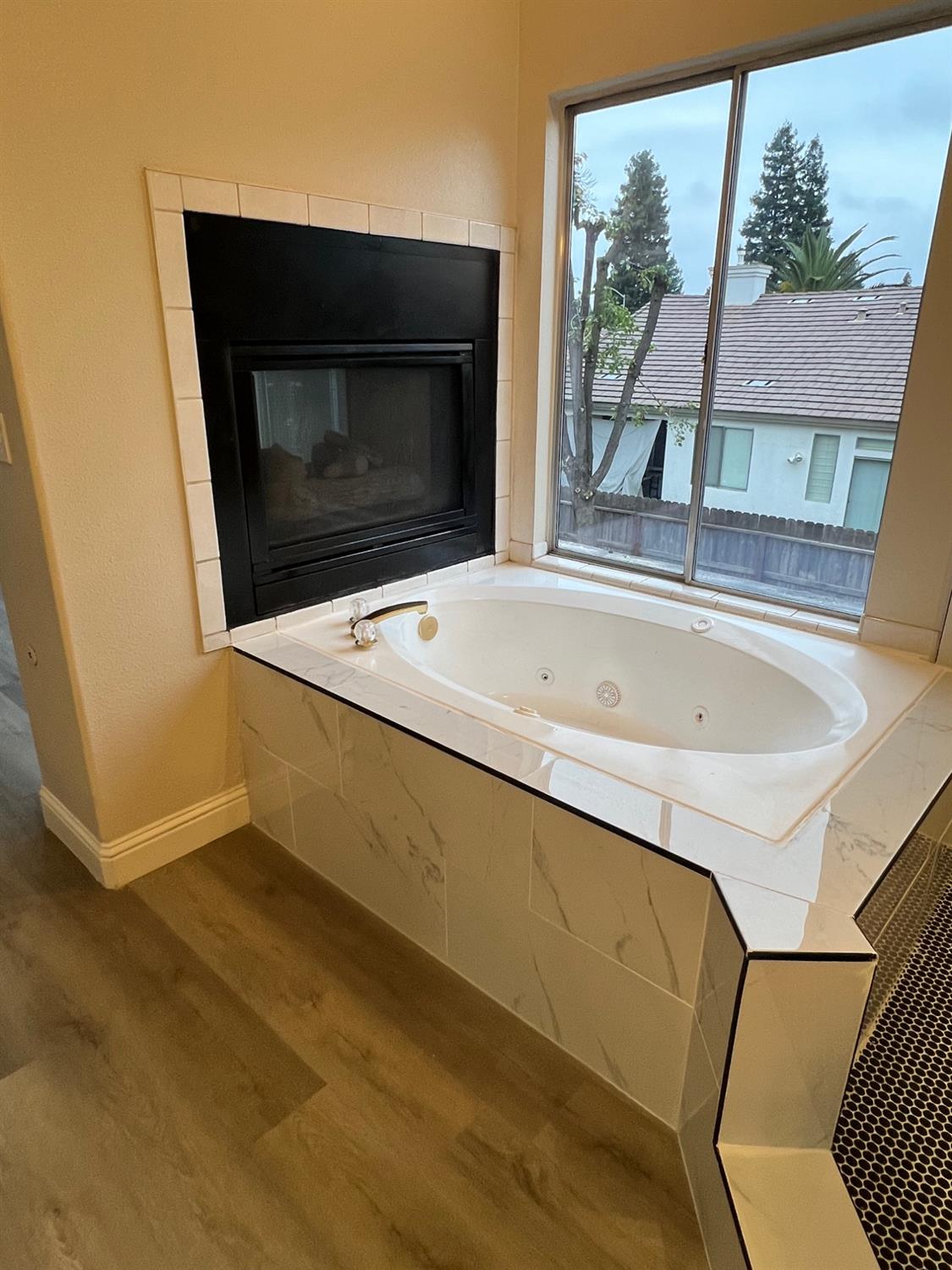 5930 West Birch Avenue Fresno, CA 93722 - Photo 21 of 32 a terrace with fireplace and wooden floor