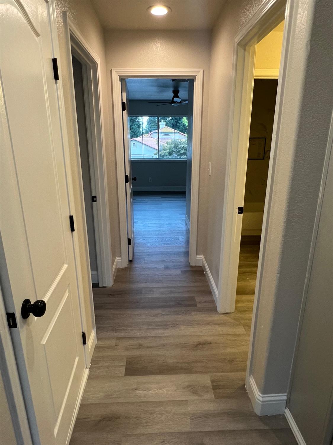 5930 West Birch Avenue Fresno, CA 93722 - Photo 22 of 32 a view of a hallway with wooden floor and staircase