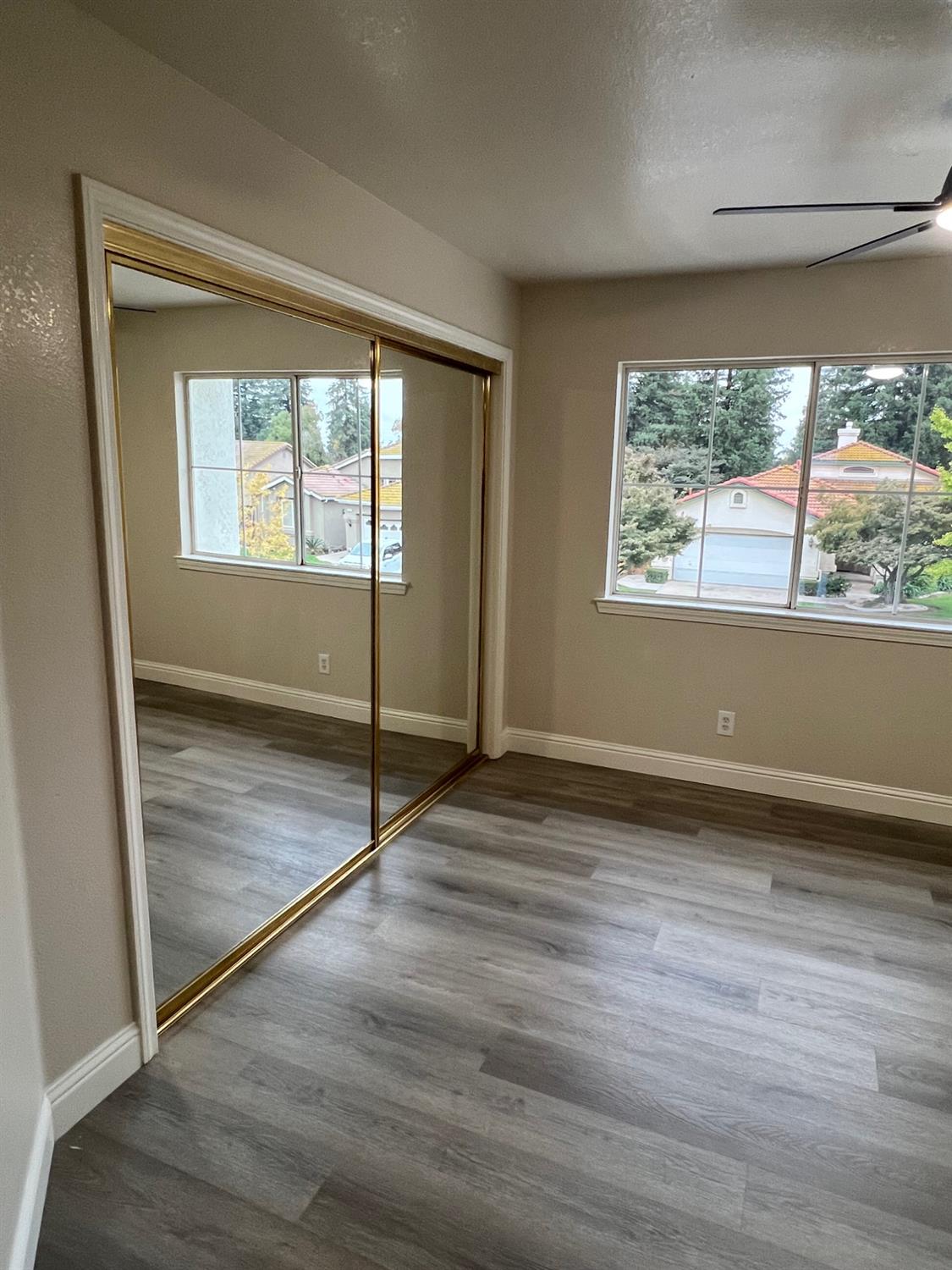 5930 West Birch Avenue Fresno, CA 93722 - Photo 25 of 32 an empty room with wooden floor and windows