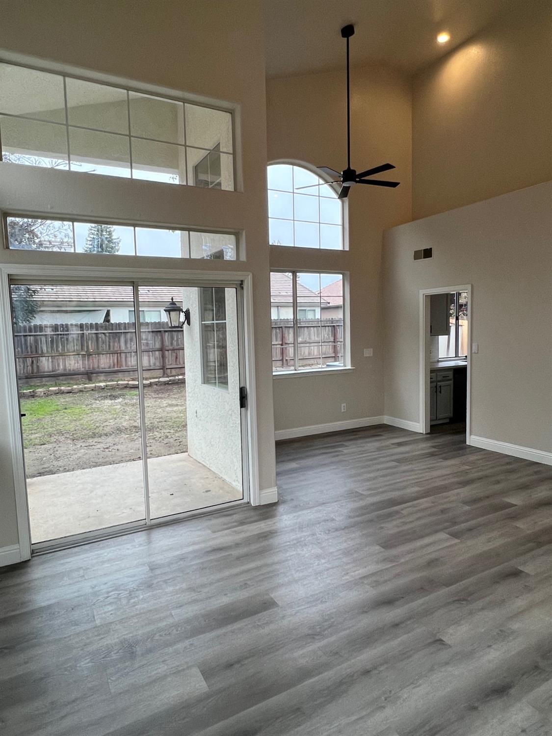 5930 West Birch Avenue Fresno, CA 93722 - Photo 5 of 32 a view of a room with wooden floor and windows