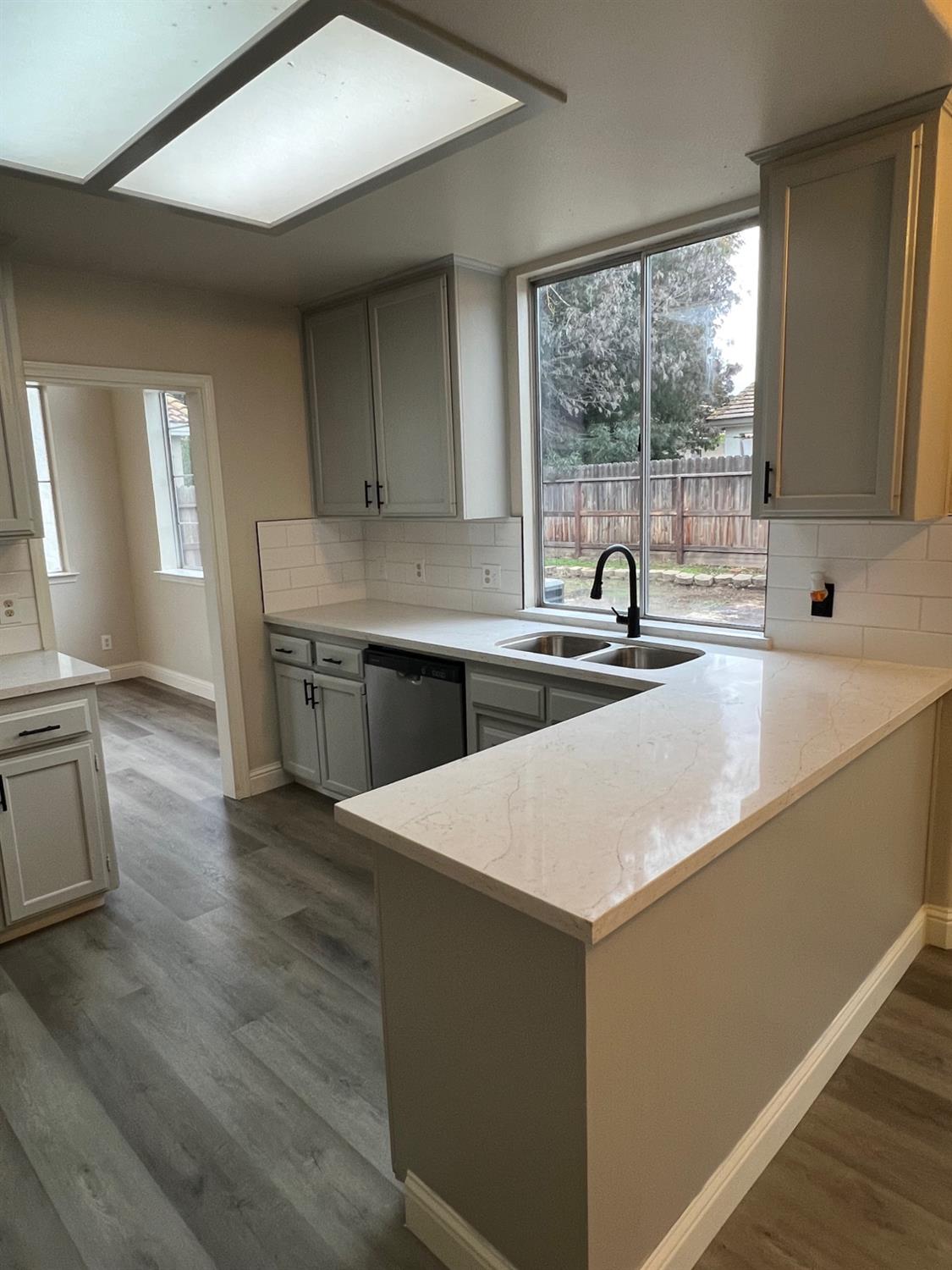5930 West Birch Avenue Fresno, CA 93722 - Photo 10 of 32 a kitchen with a sink and large window