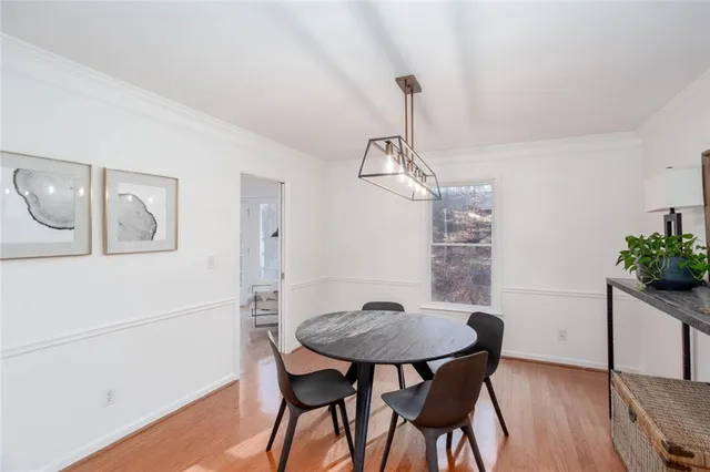 a view of a dining room with furniture and wooden floor