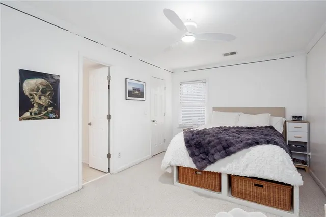 a bedroom with a bed and a painting on the wall