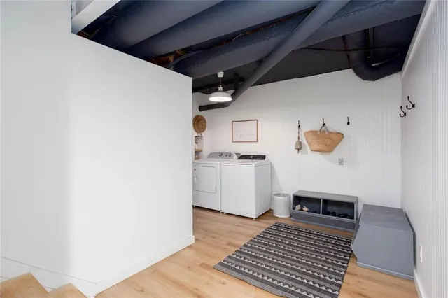 a view of a kitchen with white cabinets and wooden floor