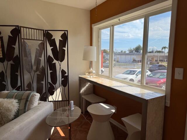 a dining room with furniture and a floor to ceiling window