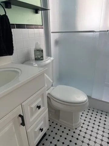 a bathroom with a sink toilet and shower