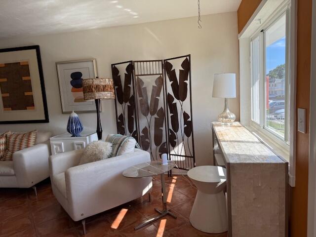 3402 Cynthia Lane, Unit 112 Lake Worth Beach, FL 33461 - Photo 20 of 41 a living room with furniture and a flat screen tv