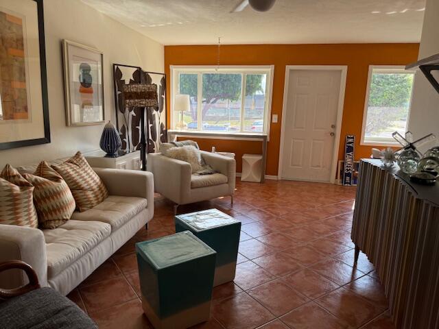 3402 Cynthia Lane, Unit 112 Lake Worth Beach, FL 33461 - Photo 2 of 41 a living room with furniture and a flat screen tv
