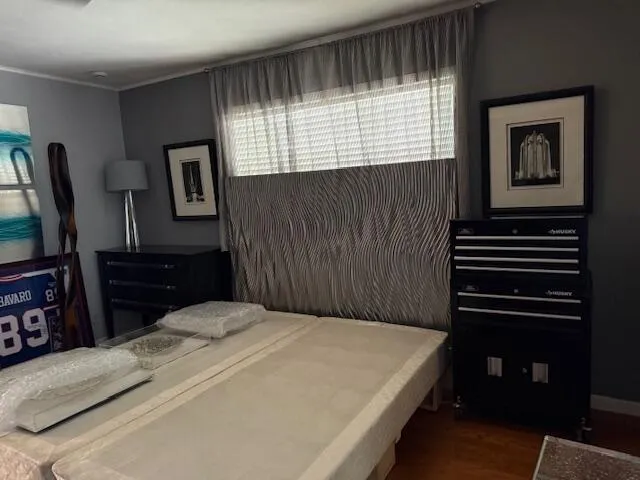 a bedroom with a bed and a television
