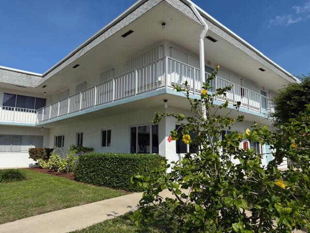 3402 Cynthia Lane, Unit 112 Lake Worth Beach, FL 33461 - Photo 31 of 41 a front view of a house with a yard