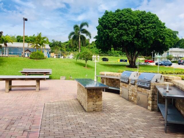 3402 Cynthia Lane, Unit 112 Lake Worth Beach, FL 33461 - Photo 32 of 41 a view of backyard with seating area and green space