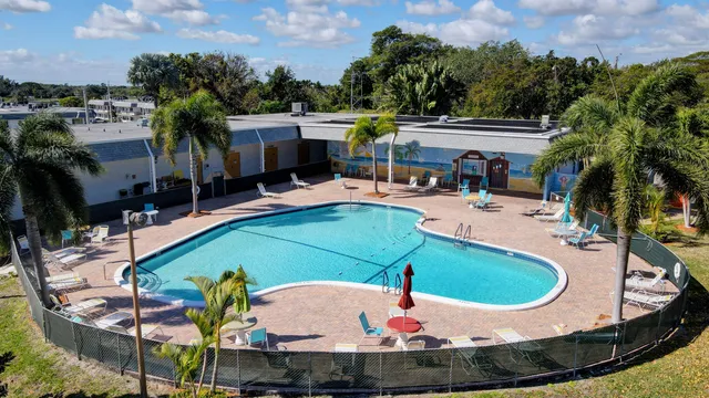 an aerial view of a house with outdoor space patio and swimming pool