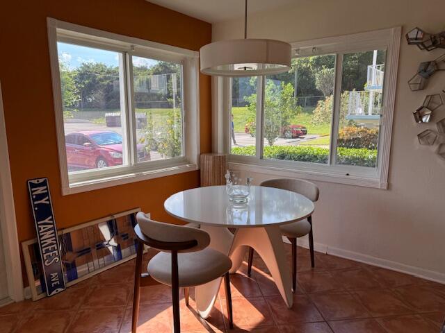 3402 Cynthia Lane, Unit 112 Lake Worth Beach, FL 33461 - Photo 4 of 41 a dining room with furniture a chandelier and wooden floor