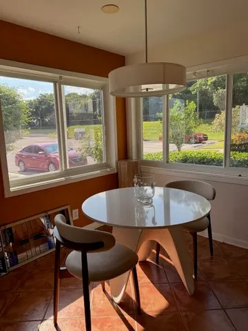 a dining room with furniture and window