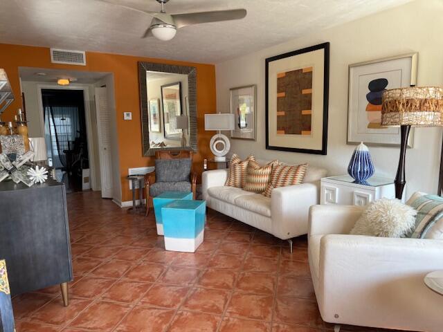 3402 Cynthia Lane, Unit 112 Lake Worth Beach, FL 33461 - Photo 9 of 41 a living room with furniture and a wooden floor