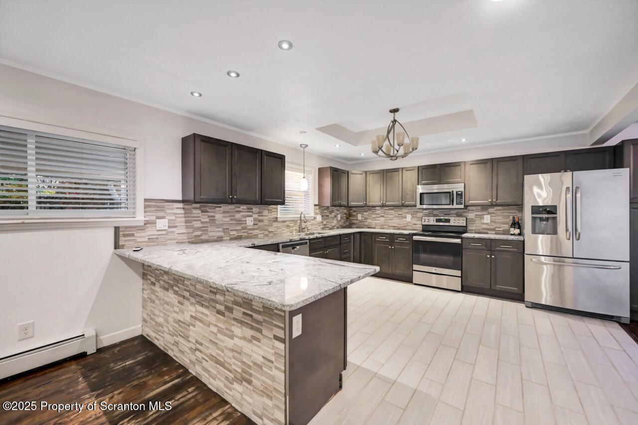 1427 Birch Street Scranton, PA 18505 - Photo 14 of 55 a large kitchen with stainless steel appliances granite countertop a stove and a sink