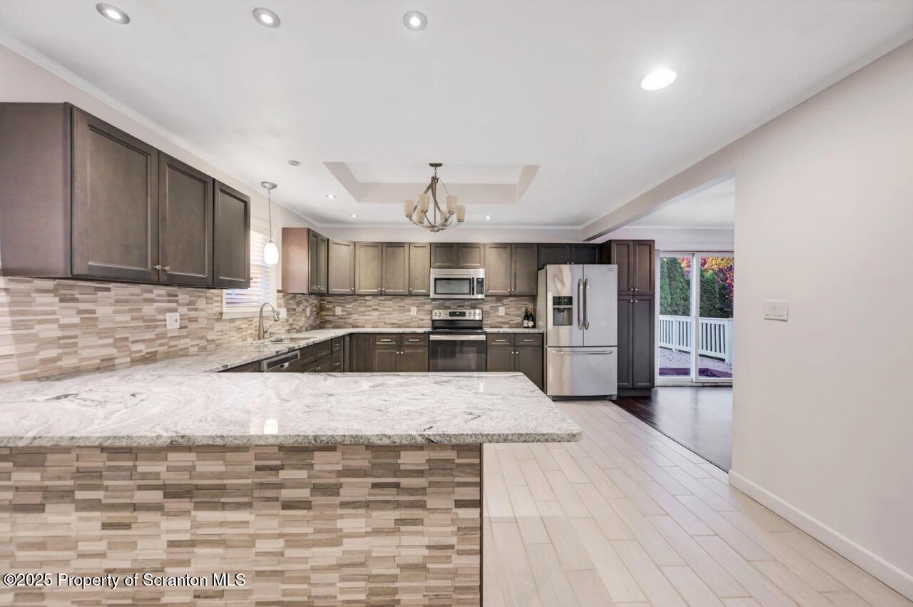 1427 Birch Street Scranton, PA 18505 - Photo 15 of 55 a large kitchen with cabinets wooden floor and stainless steel appliances