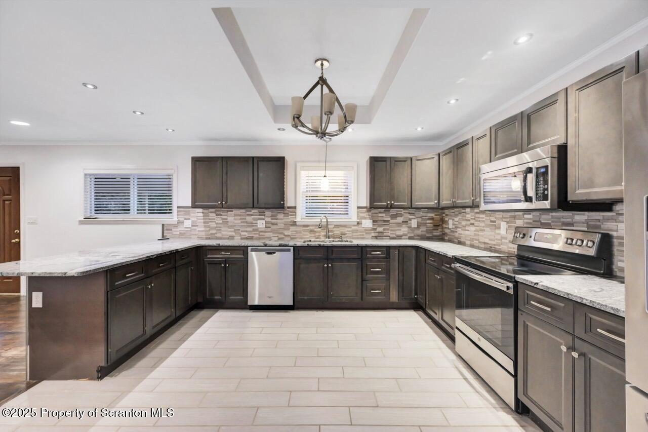 1427 Birch Street Scranton, PA 18505 - Photo 18 of 55 a large kitchen with stainless steel appliances granite countertop a stove granite counter tops and white cabinets