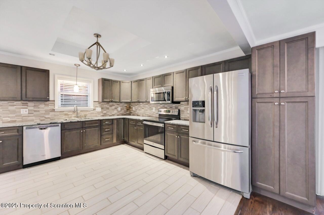 1427 Birch Street Scranton, PA 18505 - Photo 20 of 55 a kitchen with granite countertop stainless steel appliances a refrigerator a sink cabinets and wooden floor