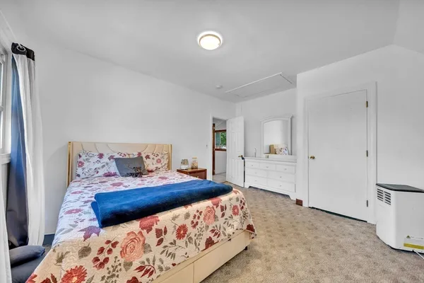 a bedroom with a large bed and a couch