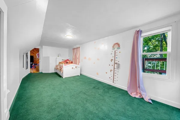 a bed room with a bed and a window