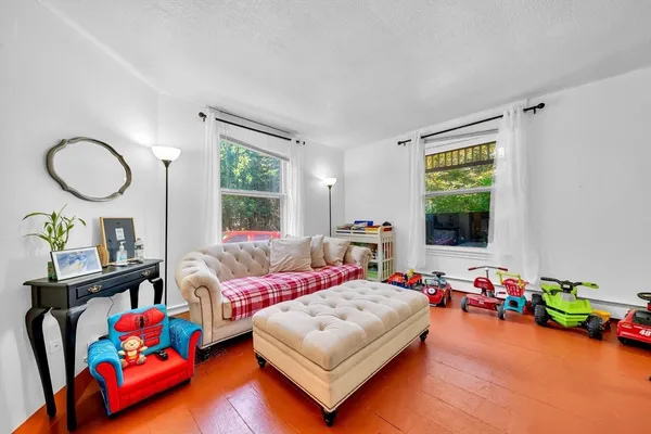 a bedroom with furniture and a wooden floor