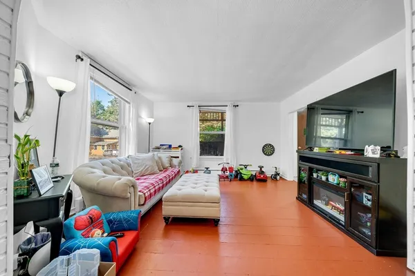 a bedroom with furniture and a flat screen tv