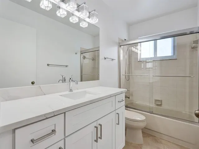 a view of a hallway with wooden floor and closet