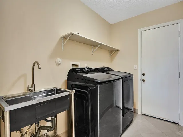 a bathroom with a double vanity sink and mirror