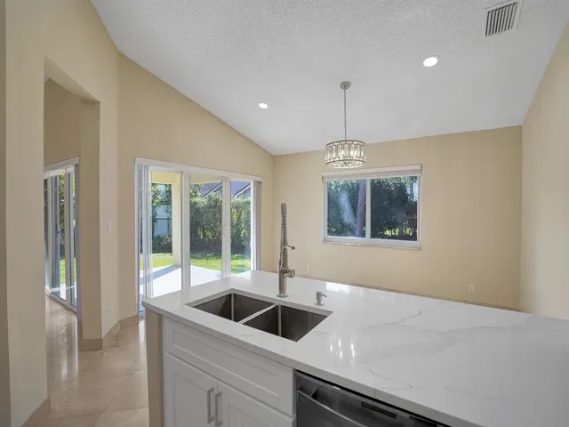 a view of a kitchen with a stove cabinets