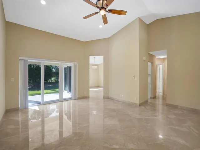 an empty room with closet and fan