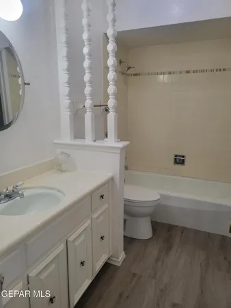 a bathroom with a double vanity sink toilet mirror and bathtub