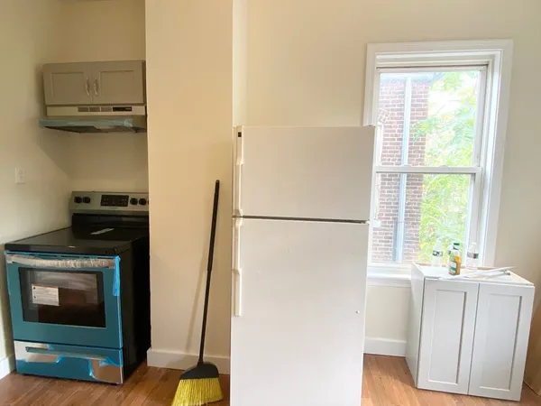 a view of a kitchen with a refrigerator washer and a window