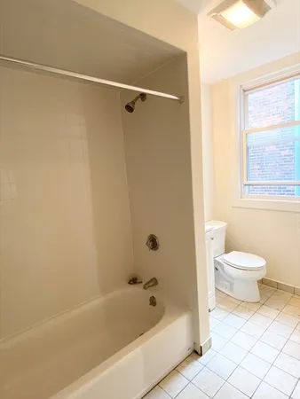 a bathroom with a toilet and a bathtub