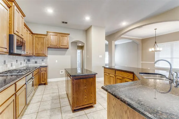 a living room with stainless steel appliances granite countertop furniture a couch and a view of living room